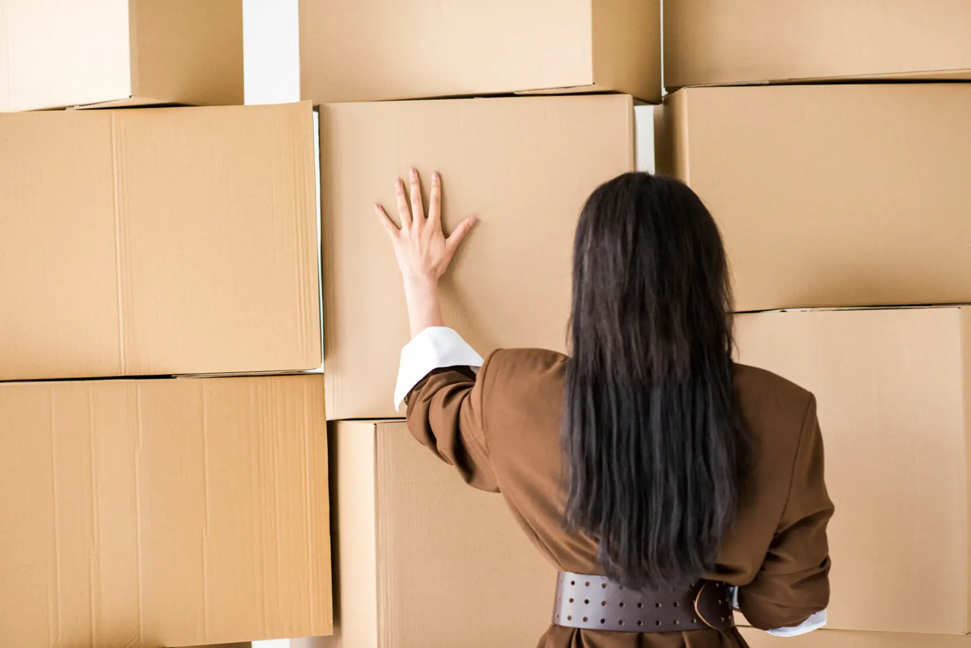 A woman stacking cardboards