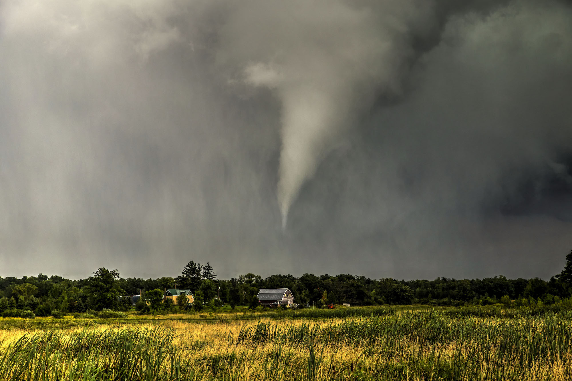 A tornado wreaking havoc in a large field