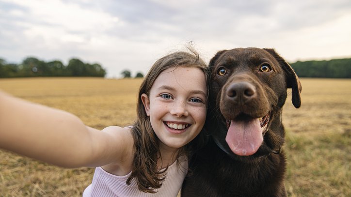 a little girl and a dog