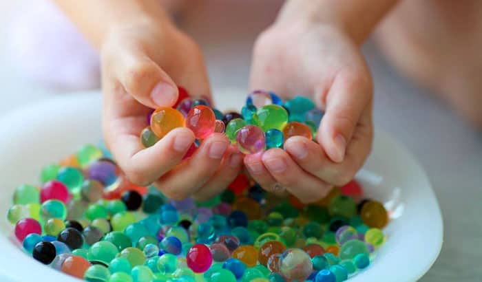 person playing with orbeez