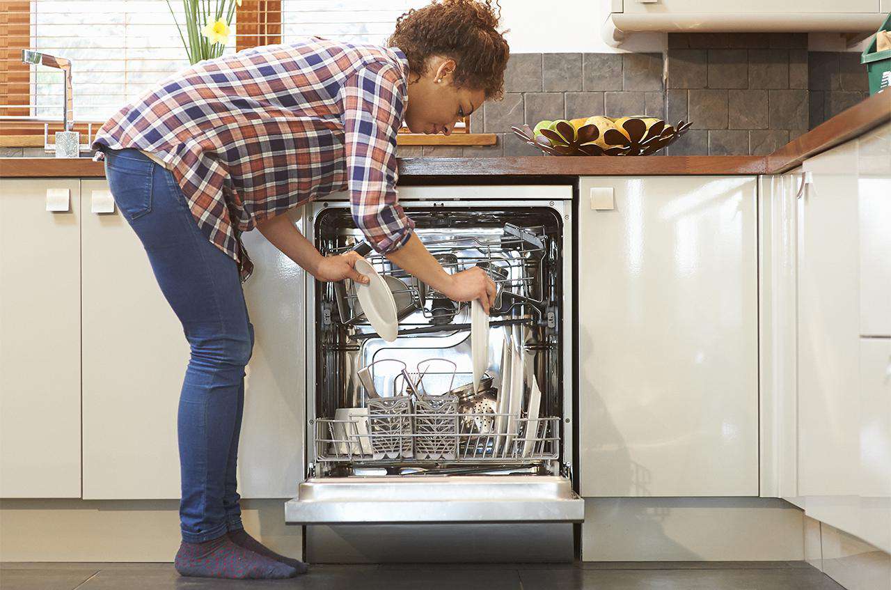 woman loading a dishwasher